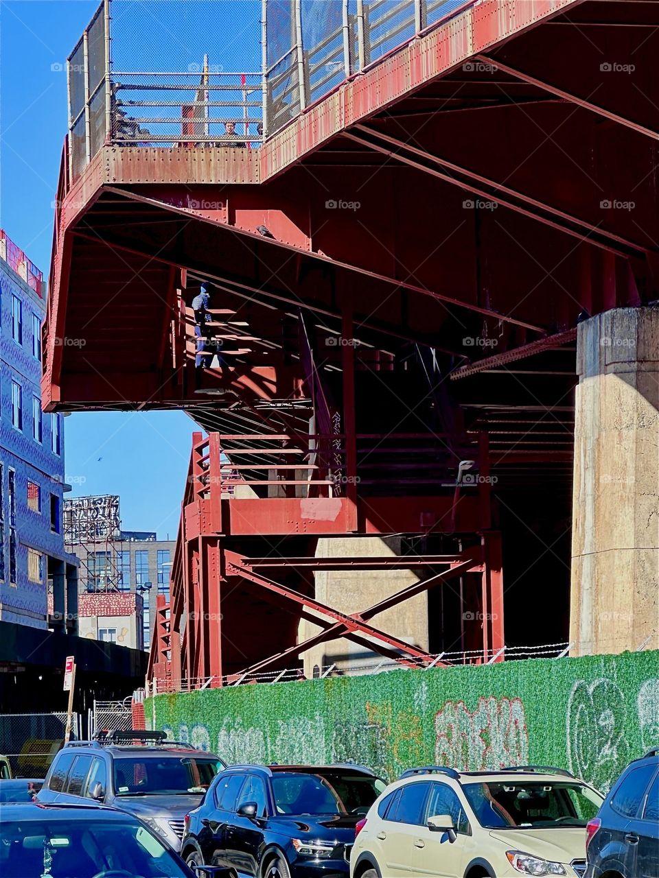This is the red metal staircase and support structures of the “Pulaski Bridge” at “Newtown Creek” in “Greenpoint”, Brooklyn, NY. This marvel of modern architecture reminds of the “Bauhaus” design school of the 1930s. 2024. Hypnotic Productions