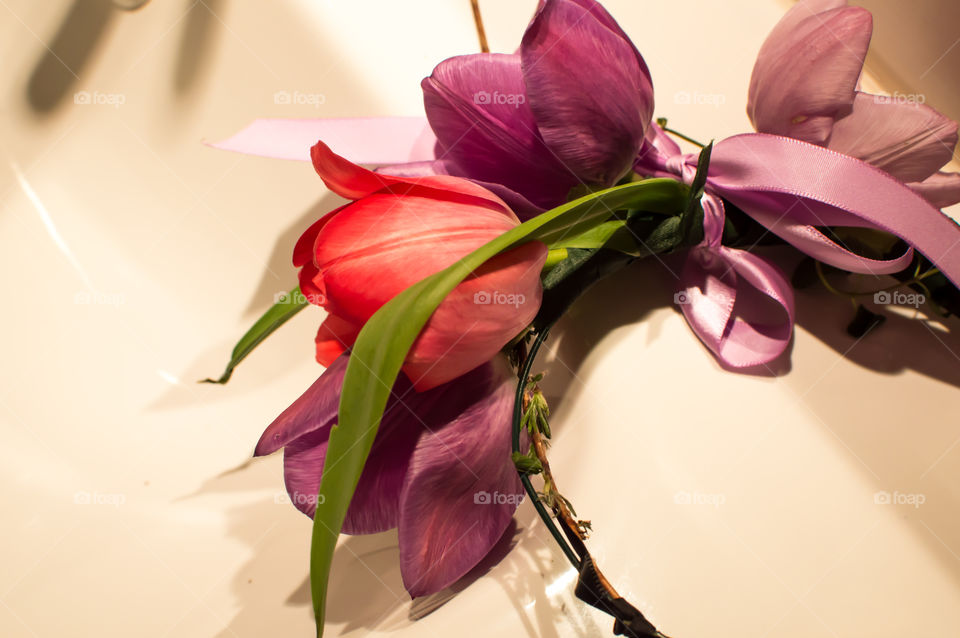 Closeup of romantic colorful flower crown with tulips in pastel pink, lavender and purple ready to wear 