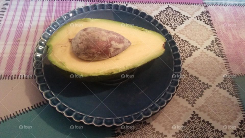 Piece of delicious avocado on plate.