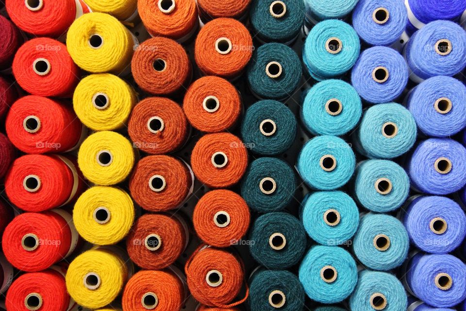 Full frame of multi colored spools