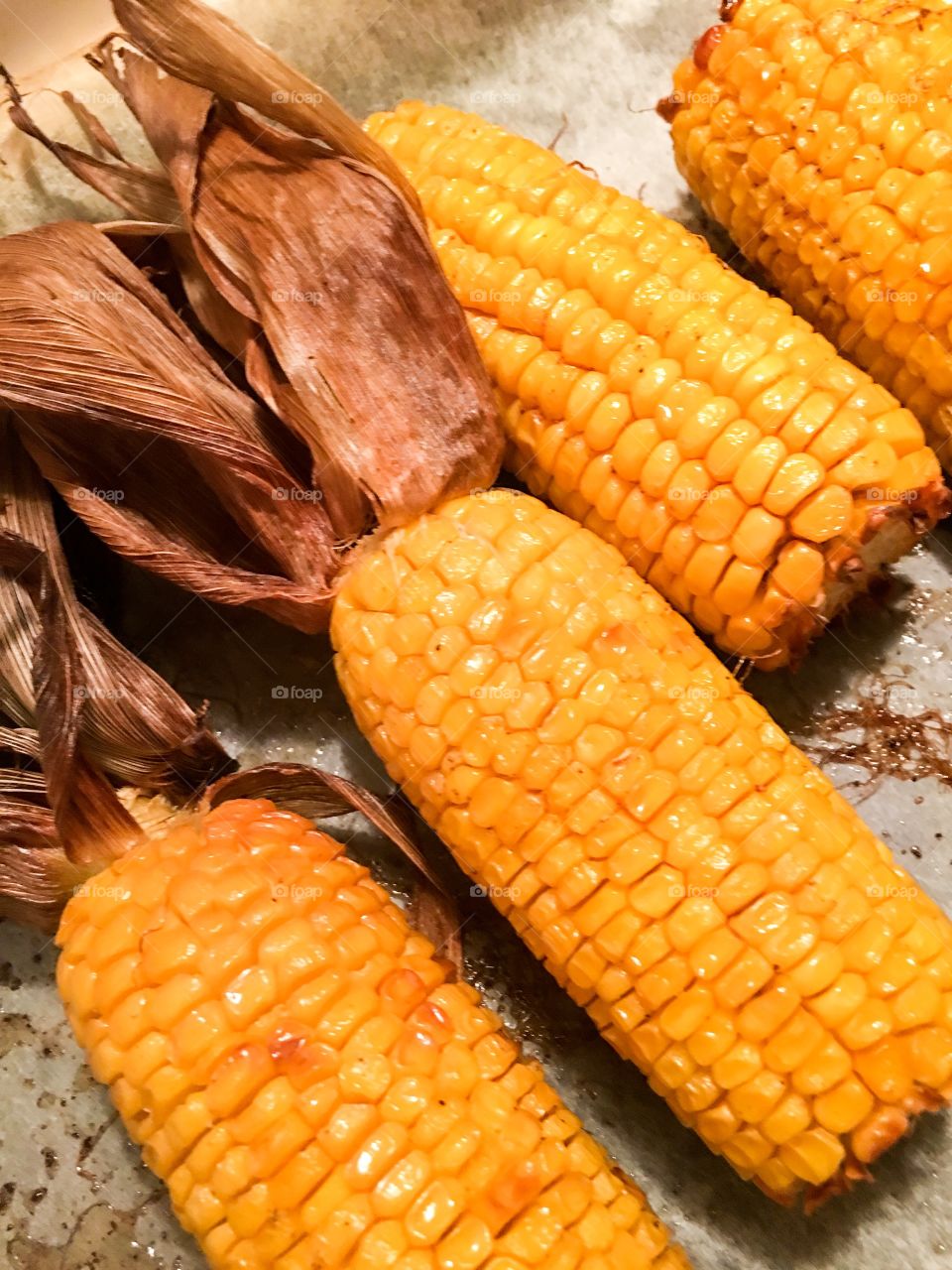 Roasted corn on the carb with the husk husks on