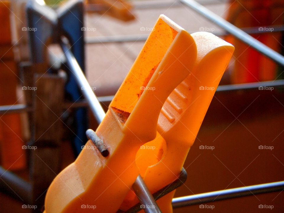 orange color story: close up of orange clothespin detail