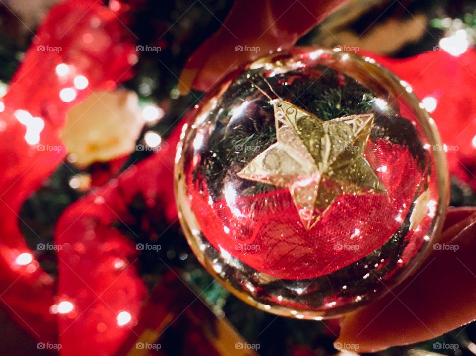 Abstract of a Christmas star as seen through a crystal lens ball.   
