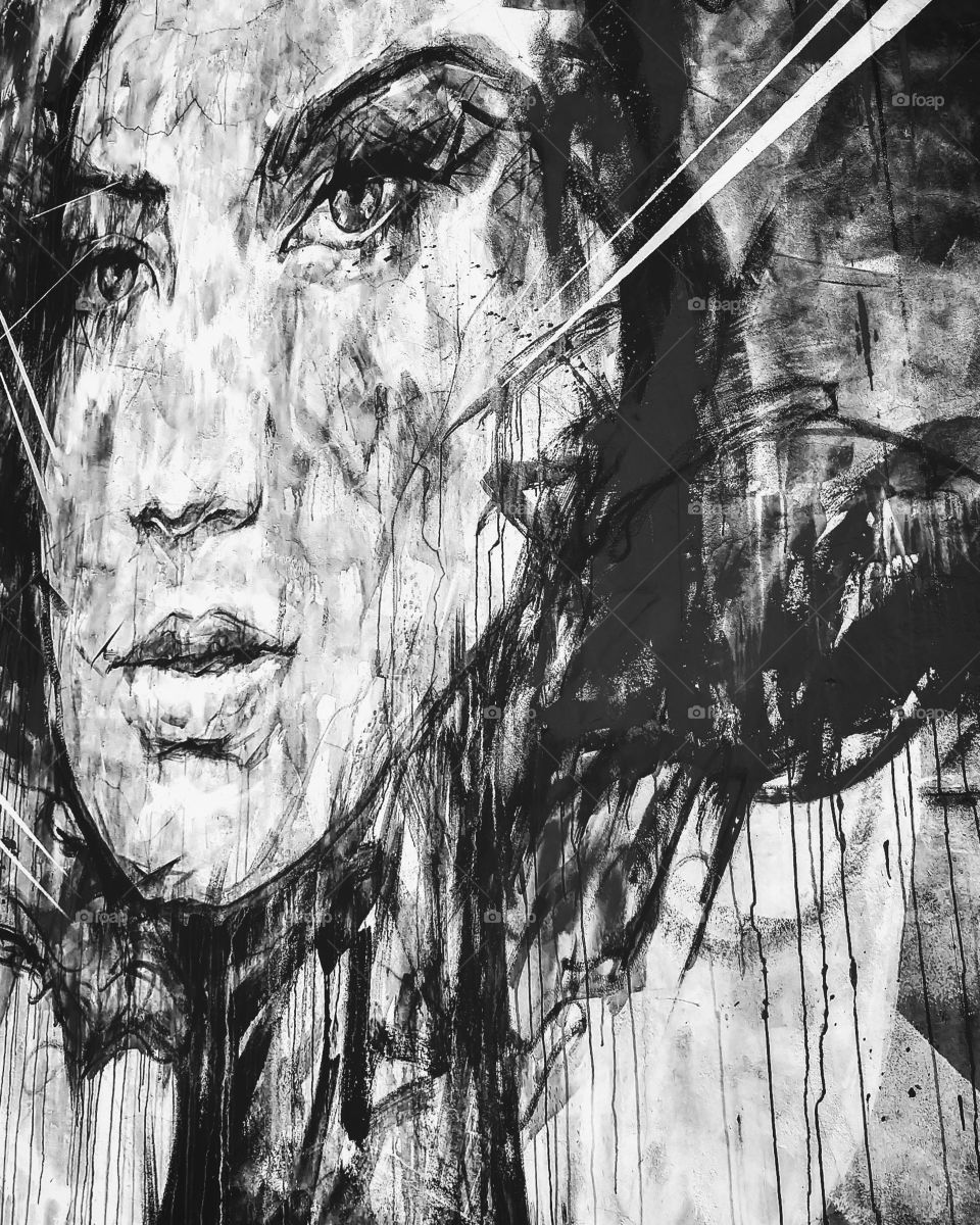 Street art graffiti in black and white. Powerful woman. Intense look