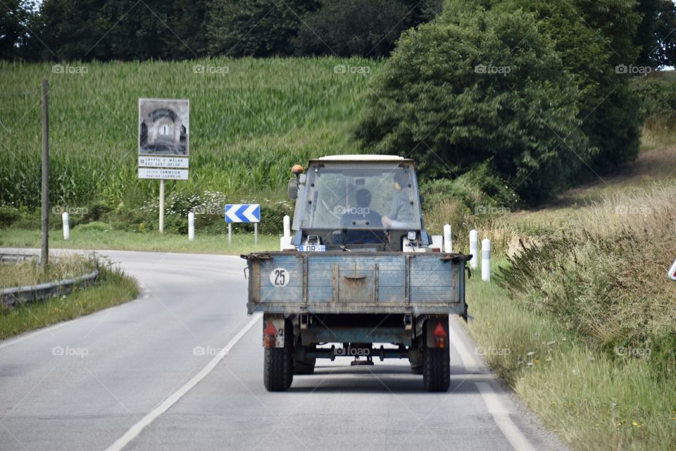 Tractor in a road in a farming scene