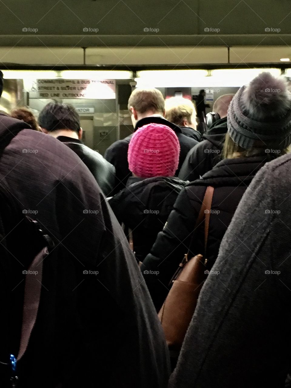 A pink hat in a black winter jackets oceans 