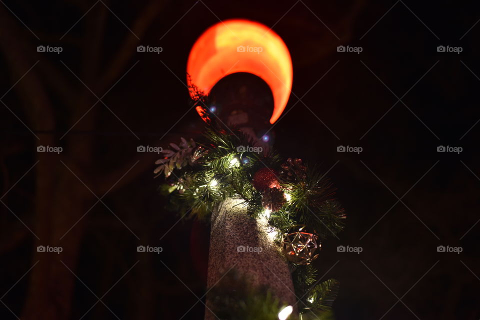 Prespective of a street lamp from below during holidays