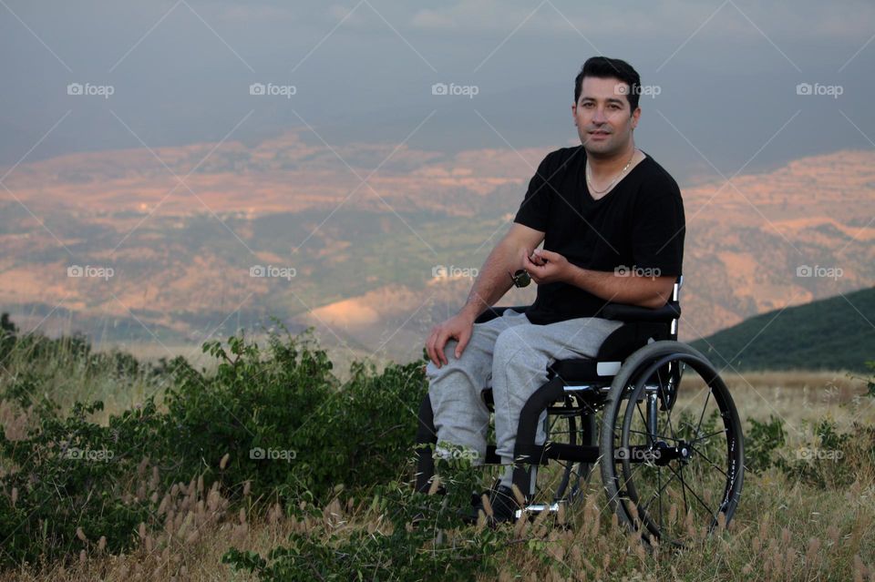 Travel on mountain by friends and wheelchair 