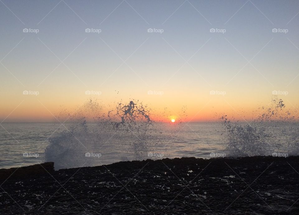 Sunset at Ericeira. watching the sun set while getting splashed