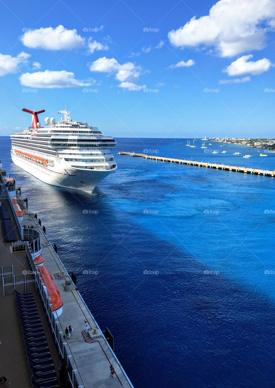 Big cruise ship arriving to the pier on the bright hot sunny day