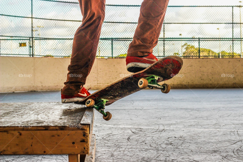 Skateboarder doing a grind on a box