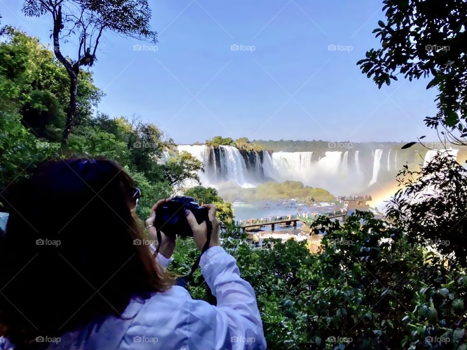 Woman photographing the waterfalls of Foz do Iguaçu, Brazil