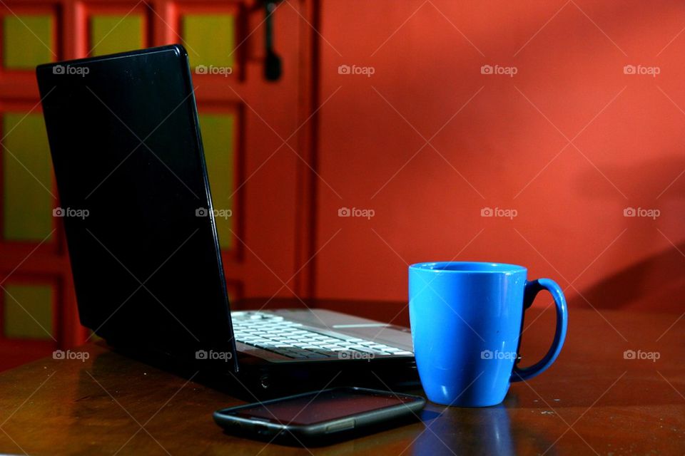 laptop computer, coffee mug and smartphone