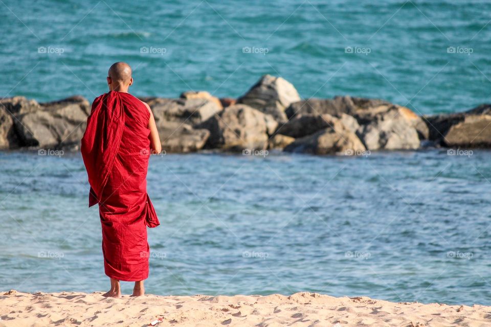 Rear view of a monk on beach