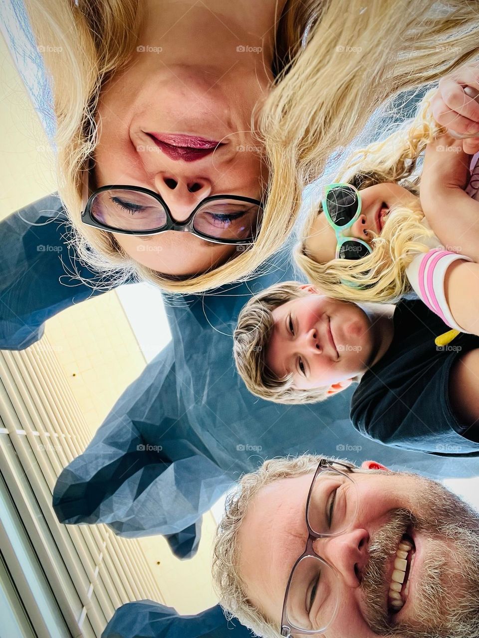 A family taking a picture with the iconic Big Blue Bear of Denver Colorado 