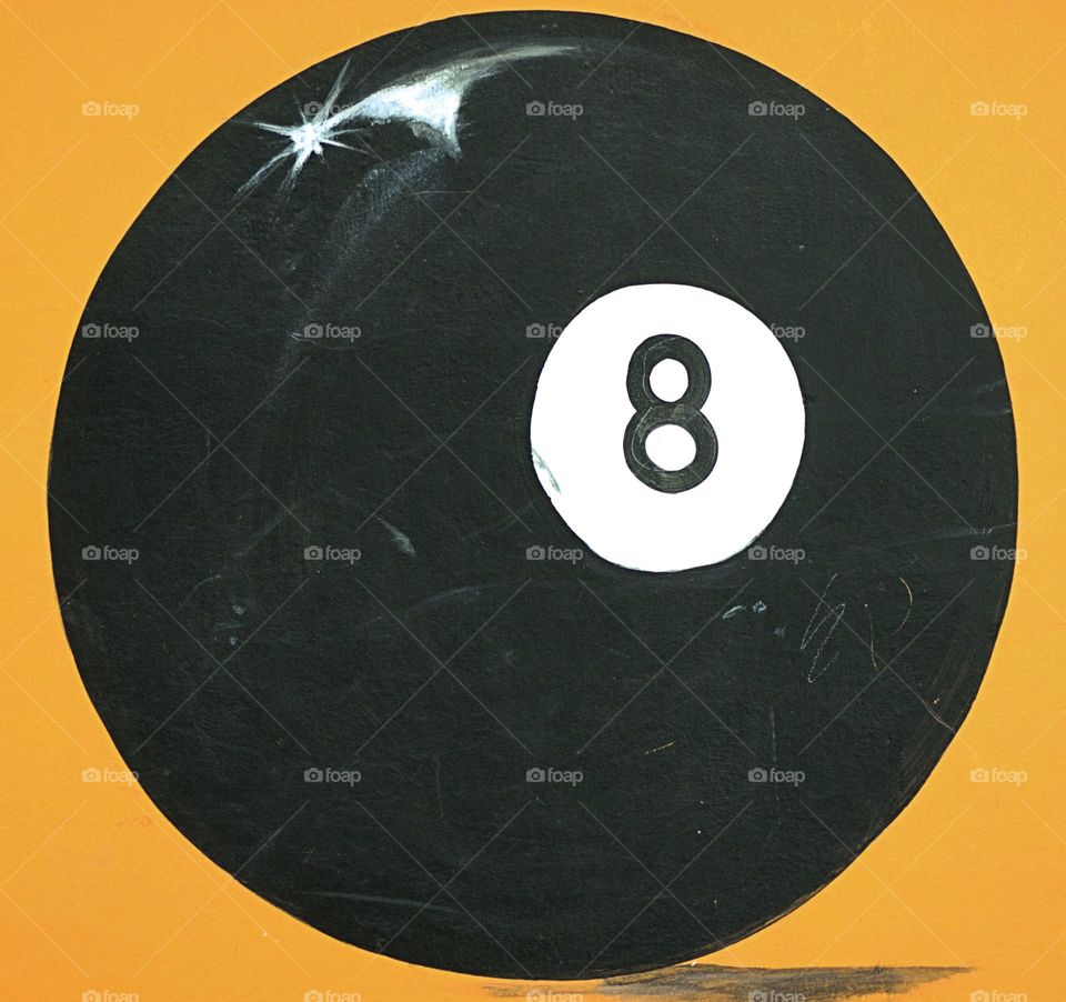 Artwork of an eight ball on the exterior wall of a building in Ixtapan de La Sal, Mexico designate the presence of pool hall.