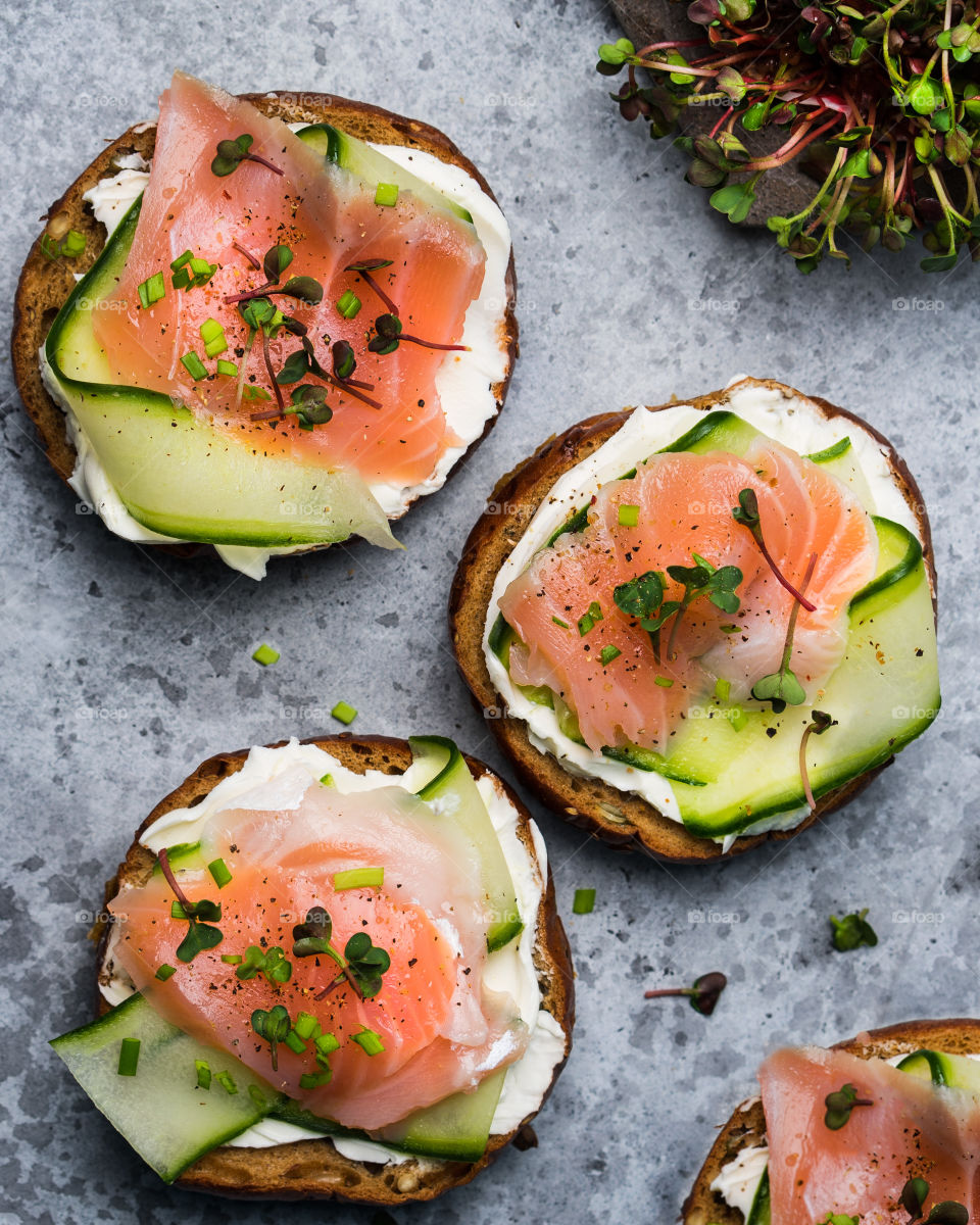 Crostini with cream cheese, cucumber and salmon. Top view.