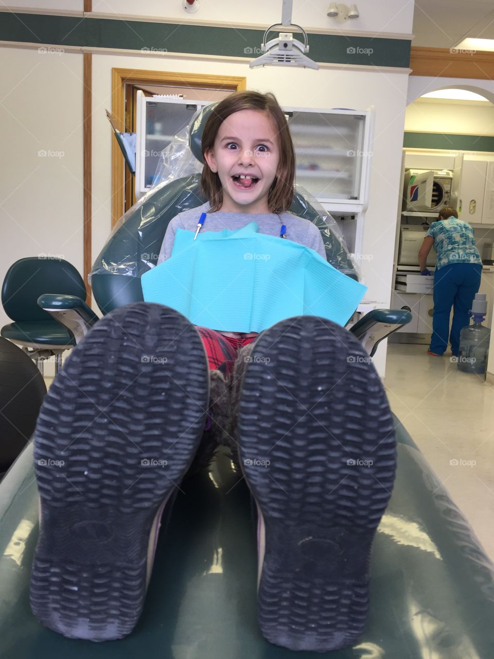 Little girl sitting on dentist chair