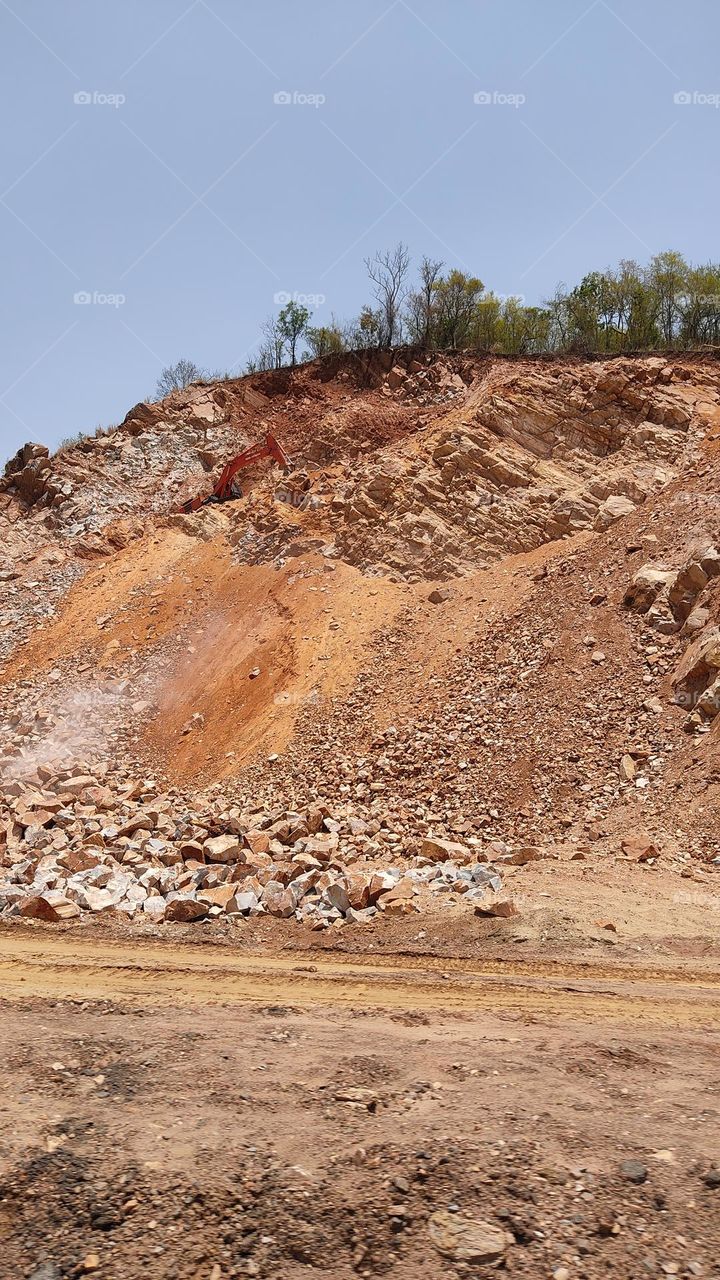 The beautiful hill is being cut.