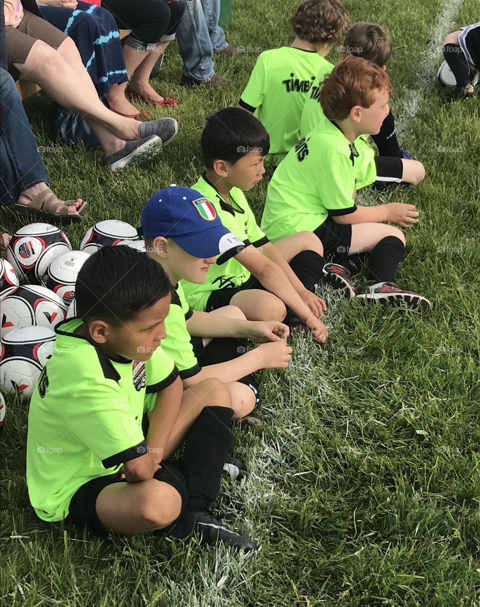Young boys learning how to play soccer for the first time