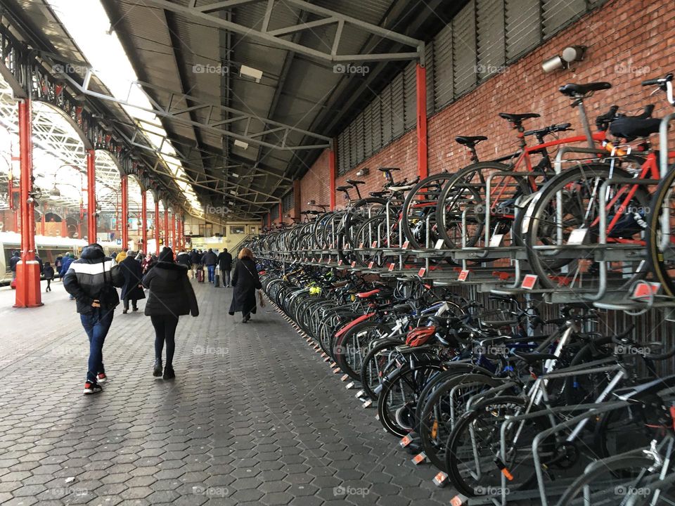 Bike rack full of city commuter cycles at a London train station 