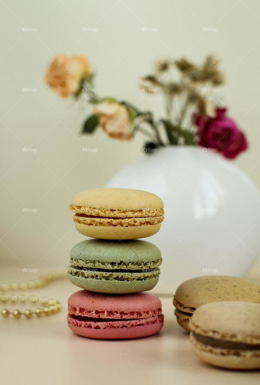 Macarons on the background of a vase with flowers