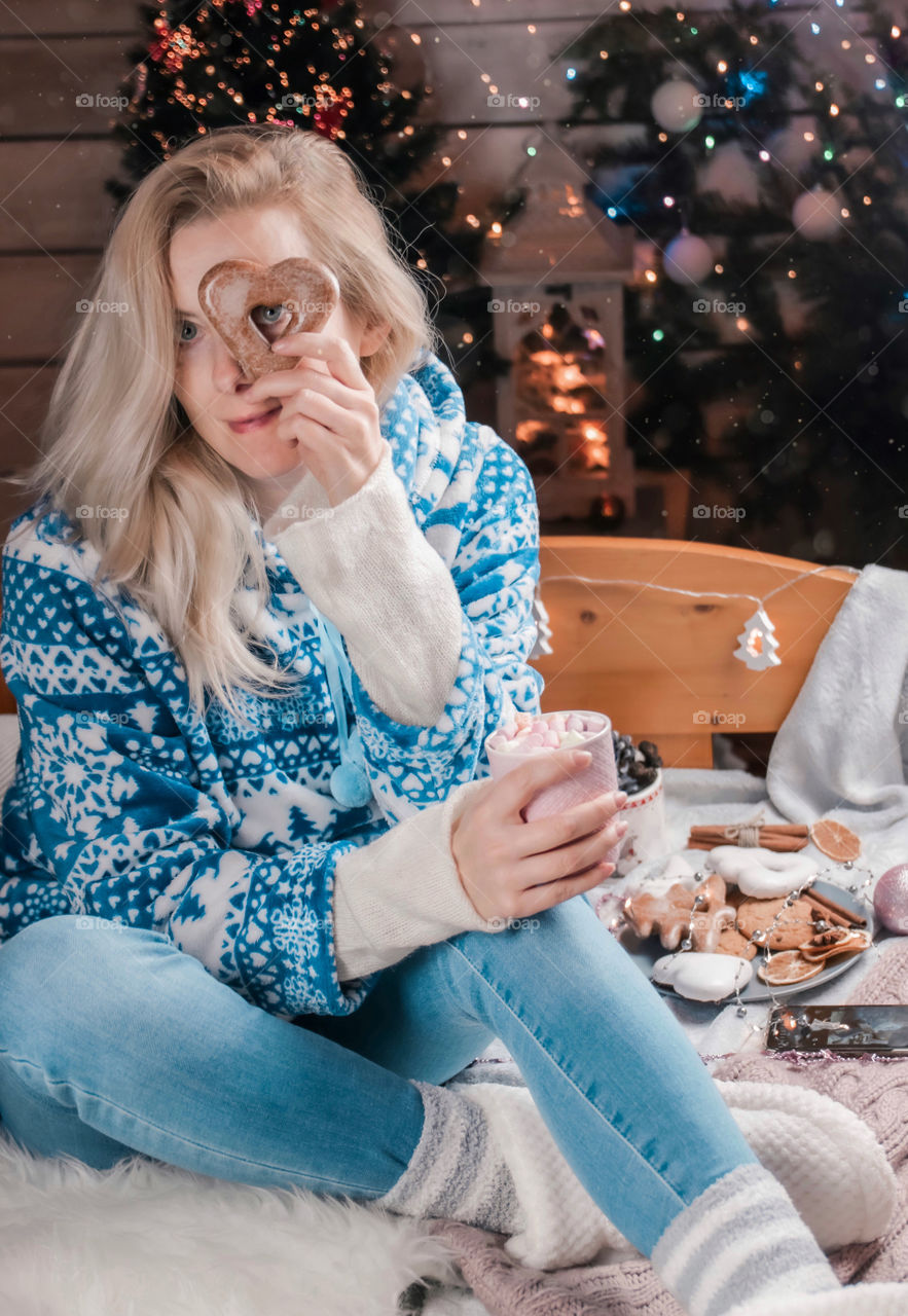 Blonde hair woman with cup of marshmallow and gingerbread