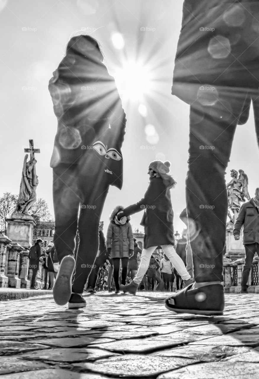 Crowd Of People Walking Under The Sun On City Busy Street