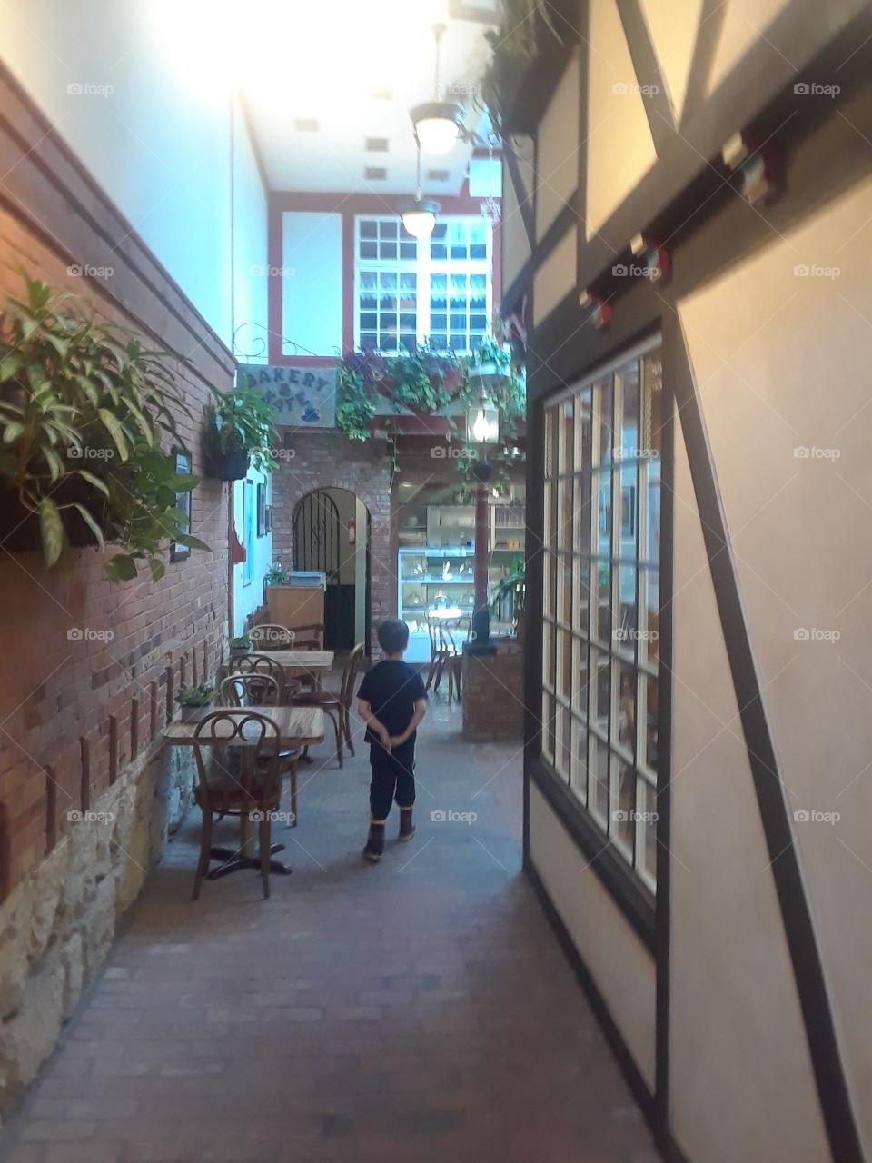 Boy walking into bakery