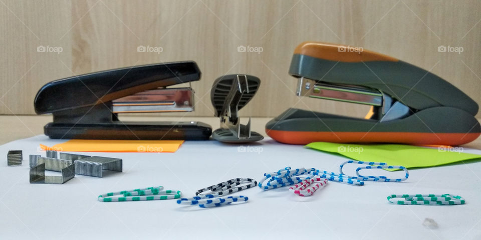 Staplers and paper clips on the paper