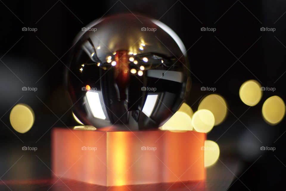 beautiful bokeh behind glass ball.  Light balls and reflections.