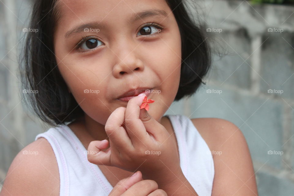 girl eating honey in flower.