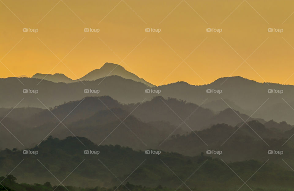 The Silhouettes of The Mountain Range at Sunrise Dawn.