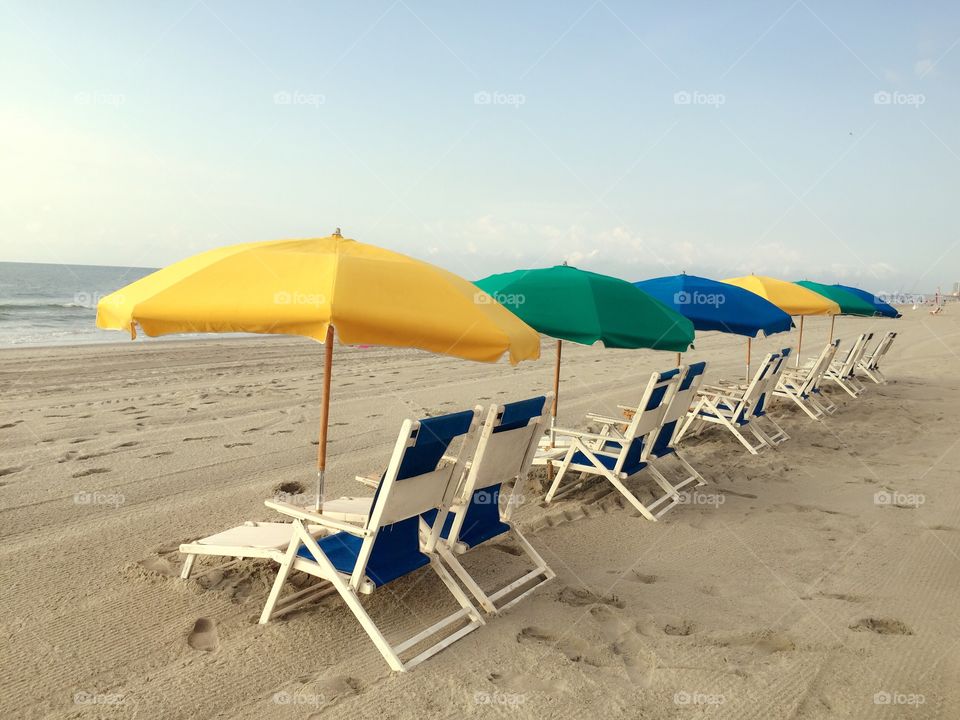 Beach chairs at dawn. Row of beach chairs taken just after Dawn in the golden hour.