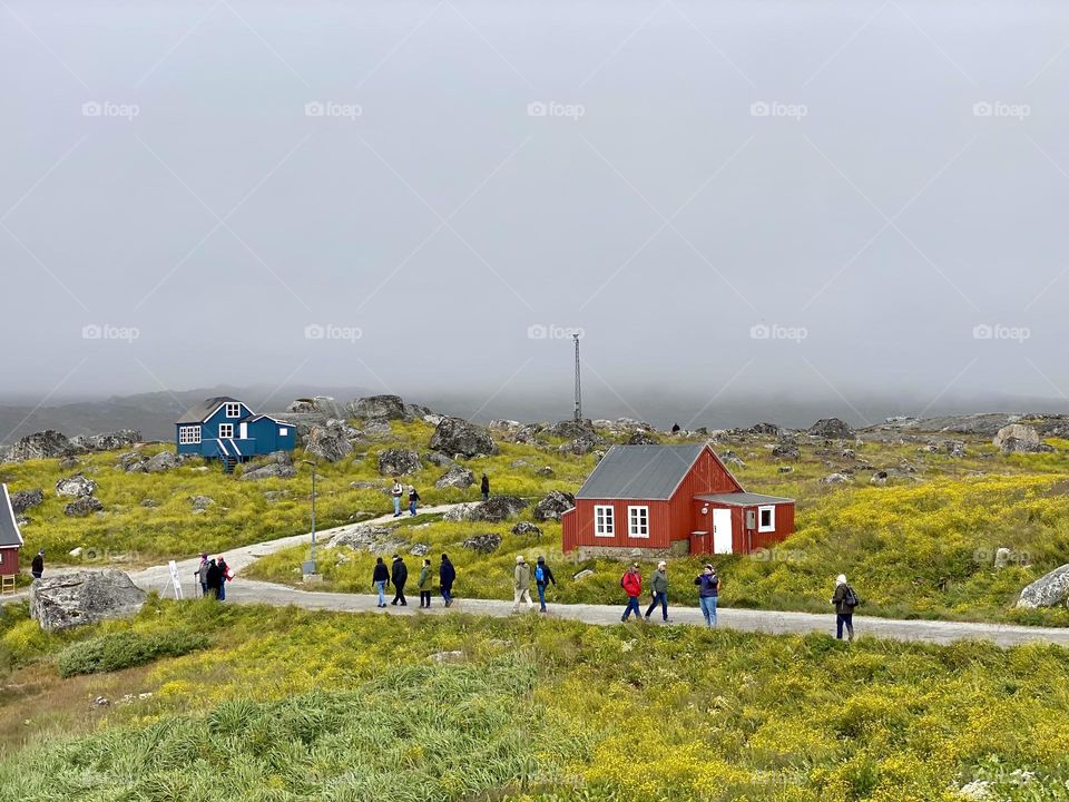 People walking down a road in a small village in Greenland 