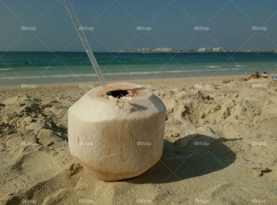 drinking coconut on the beach in Dubai during Christmas time