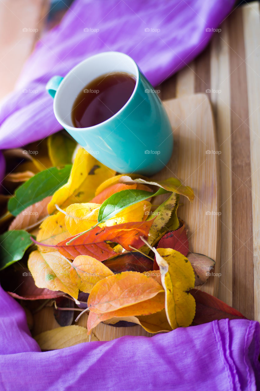 Hot flower tea in a blue mug on a wooden background