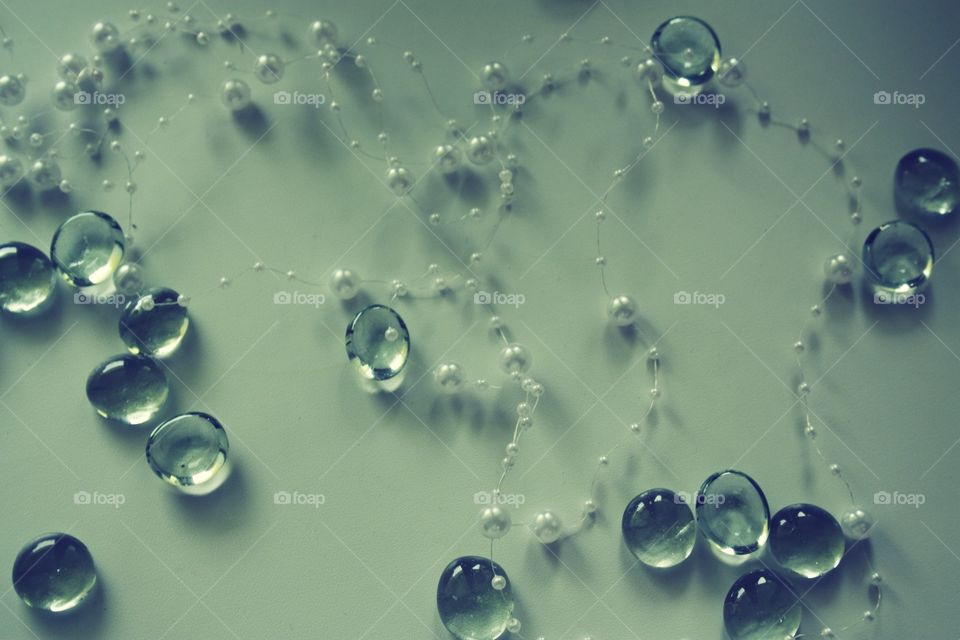 pebbles and beads on a white table