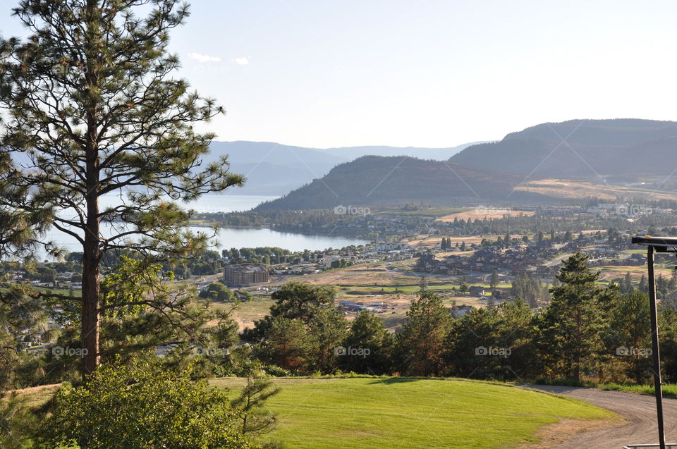 View of hill side vineyards mountains and lake 
