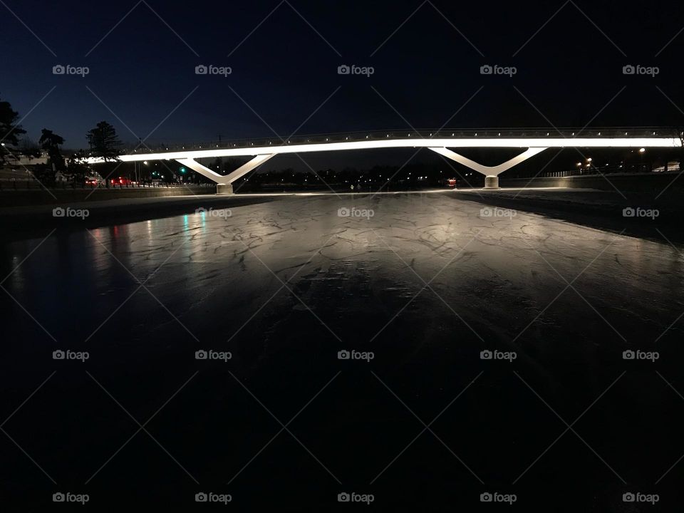 The Flora footbridge all lit up on an early morning skate on the Rideau Canal Skateway, Ottawa, Canada.