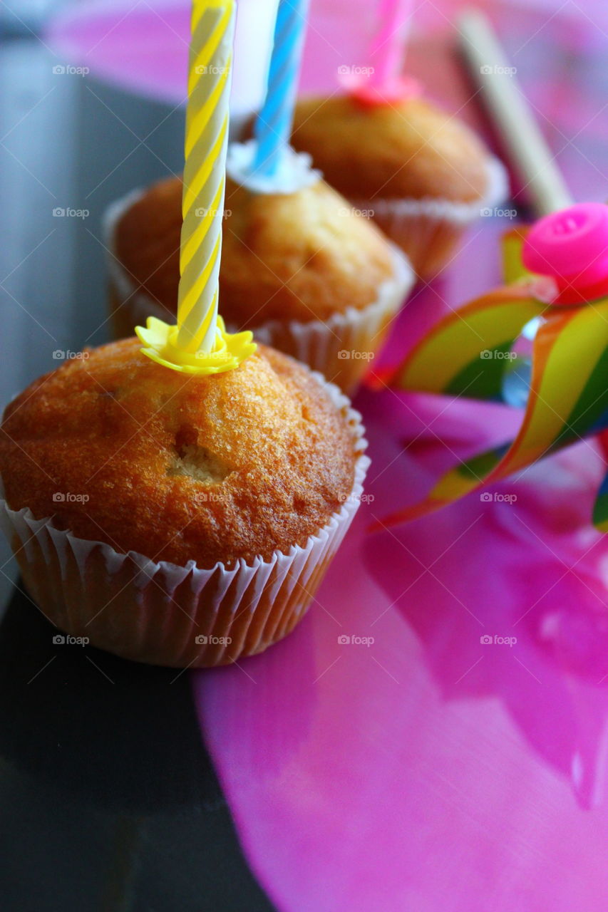 three cupcakes with candles