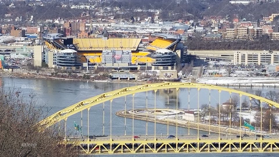Heinz Field behind a Pittsburgh bridge