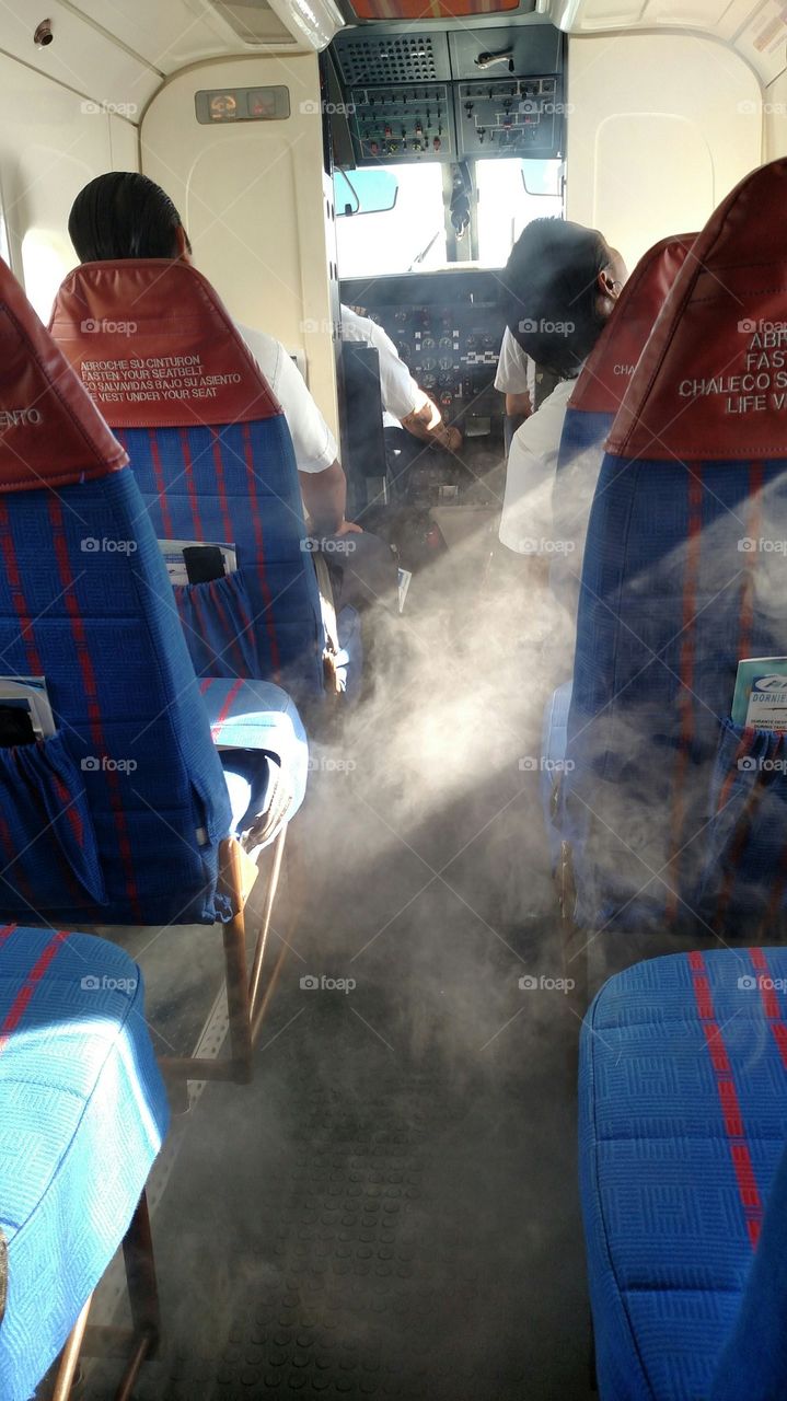 Smokin'. Condensation in the cabin gives the appearance of the plane being on fire. It was not.