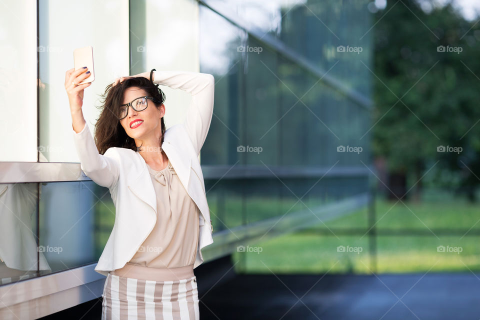 Satisfied pretty woman taking selfies 