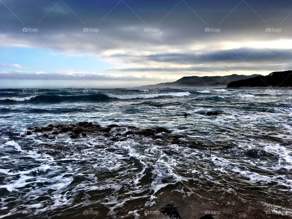 Sunset on cloudy misty beach 2