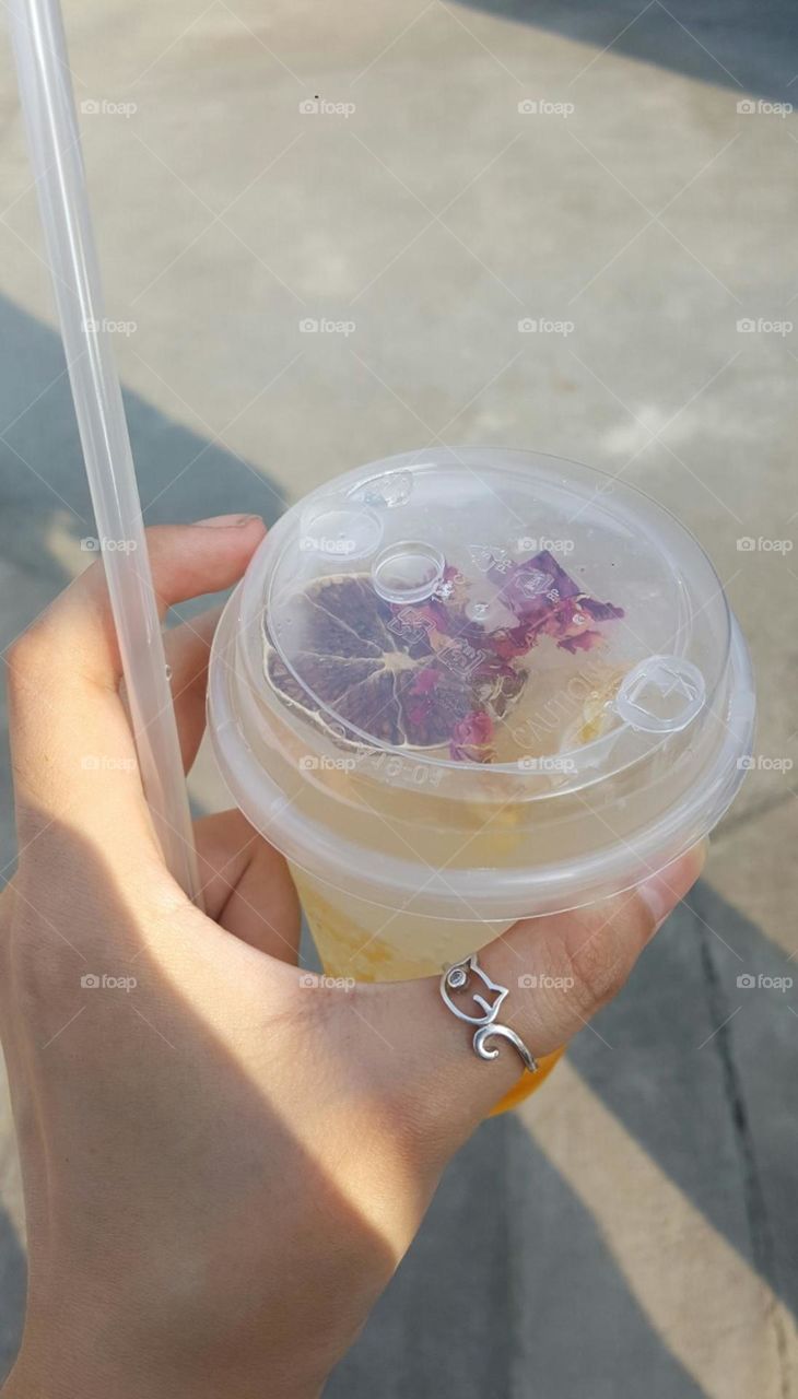 Yellow gradient drink with added dried roses and dried fruits