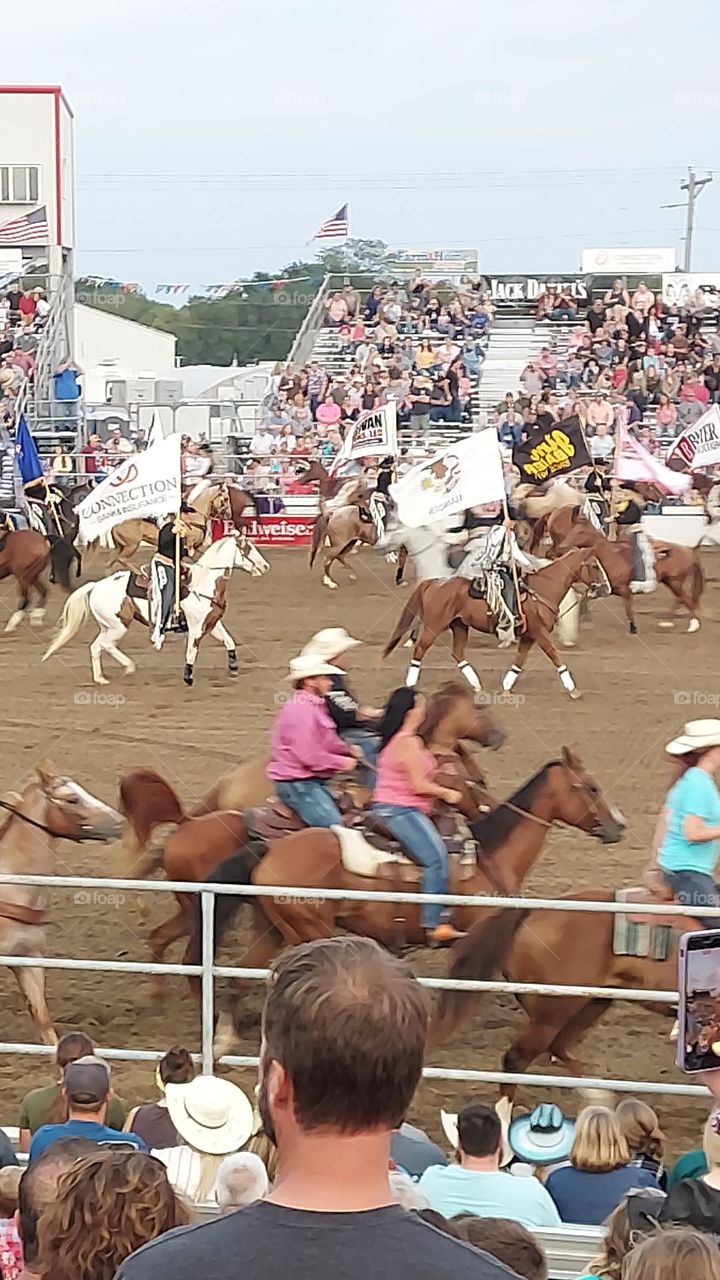 Riding horses in a rodeo