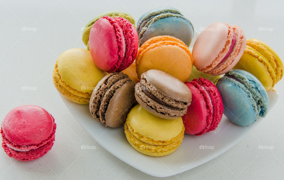 Colourful  delicious macaroons on a white plate 