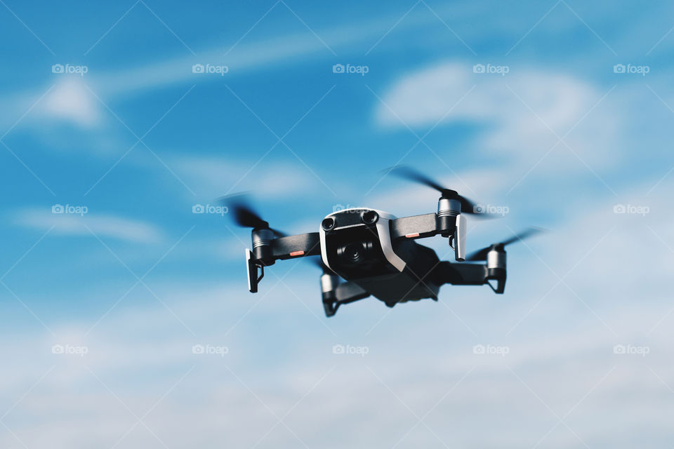 drone flies in the blue sky