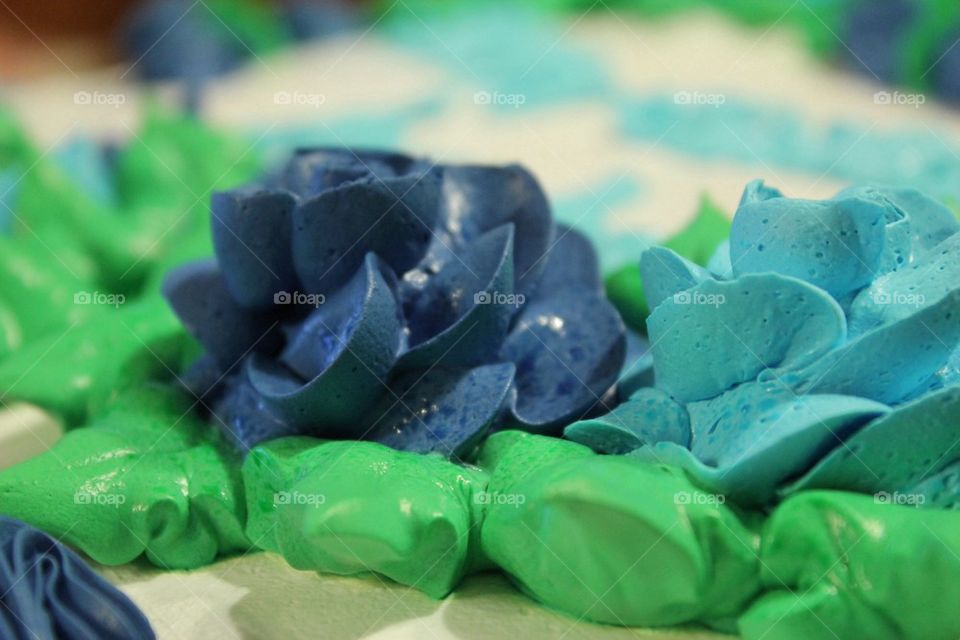Icing On The Cake - close up image of blue flower icing decorations on birthday cake 